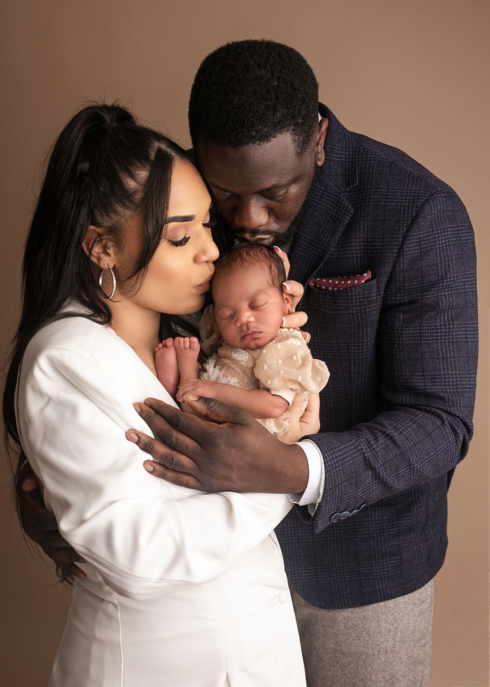 kisses baby newborn