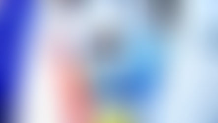 Twins in matching blue outfits joining their parent while grocery shopping. One child sits in a themed cart.