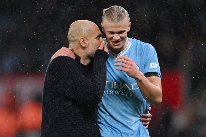 Haaland receives instructions from coach Pep Guardiola