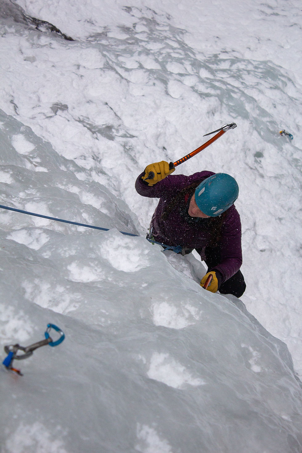 Ice climber using a dry-treated rope