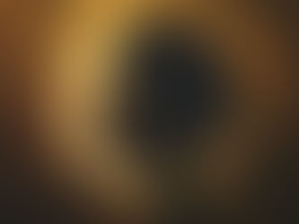 Side-profile portrait of a Black woman with afro and hoop earrings, backlit by a glowing gold ring halo in a moody haze.
