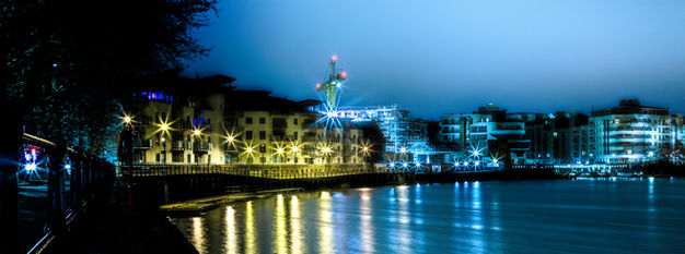 Bristol Harbourside with boats moored along the waterfront, historic buildings, and bustling quayside cafes