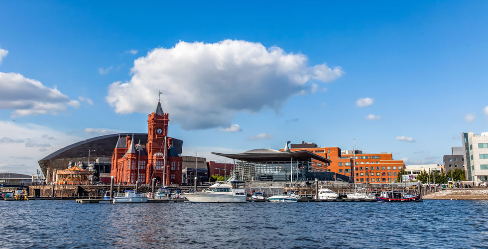 Breathtaking view of Cardiff Bay with boats and waterfront buildings under a clear blue sky