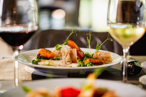 Plated gourmet dish in a restaurant setting, showcasing exquisite culinary presentation with vibrant colors and fresh ingredients