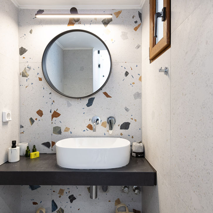 modern bathroom sink with round mirror in studio panormo crete