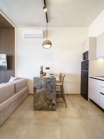 Modern kitchen in open plan suite Panormo Crete apartment