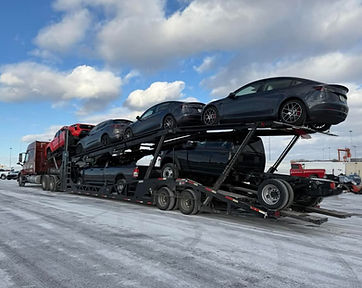 Car transporter carrying multiple vehicles.