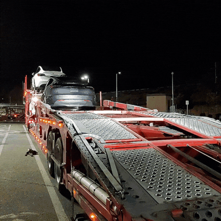 Image of car loading onto trailer with the words blog: why finish line logistics is the right auto transport broker
