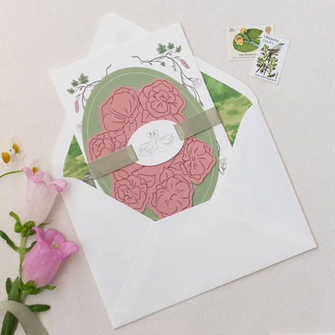 Floral wedding invitation with ribbon and white envelope