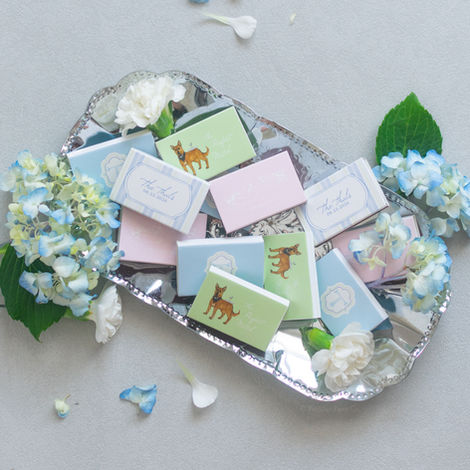 Small pastel gift boxes and flowers on a silver tray
