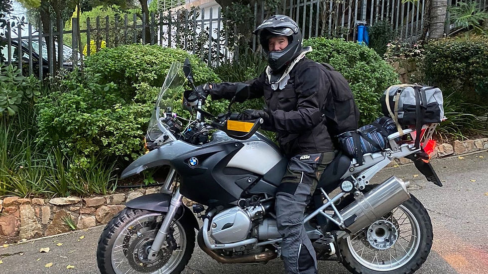 Rider on BMW GS adventure motorcycle on gravel road in the Karoo