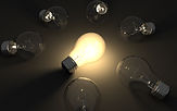 One light bulb is lit, surrounded by a group of light bulbs that are dark.