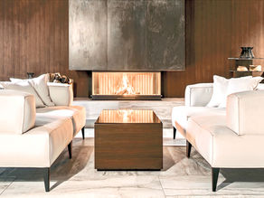 legant and serene living space in Alderley Edge, Cheshire, showcasing minimalist design with a focus on natural light and understated luxury, centered around a modern fireplace.