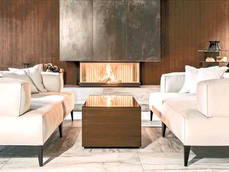 legant and serene living space in Alderley Edge, Cheshire, showcasing minimalist design with a focus on natural light and understated luxury, centered around a modern fireplace.