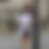 Thumbnail: Brunette woman wearing an oversized white t-shirt leans against a lamppost
