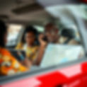 Female Ghana Expat writing in laptop. A male Ghana Expat on the telephone with a map. El