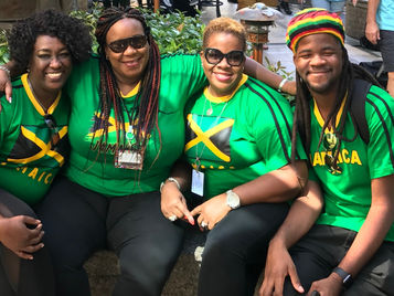 A group of friends proudly donning Jamaican-themed shirts