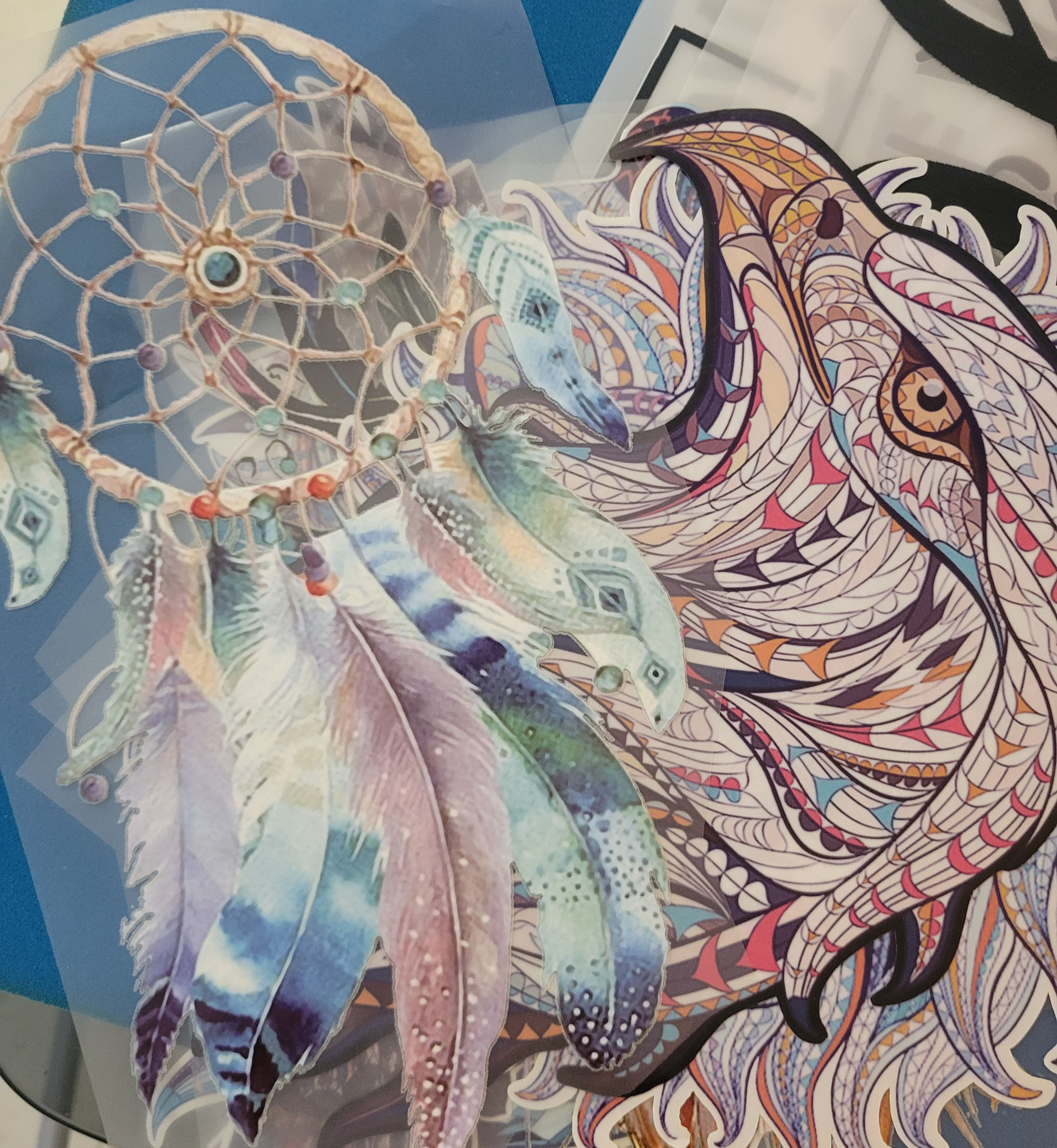 Stylized dreamcatcher with feathers and animal pattern