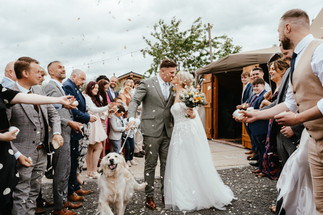 Confetti shot, bride and groom with their dog