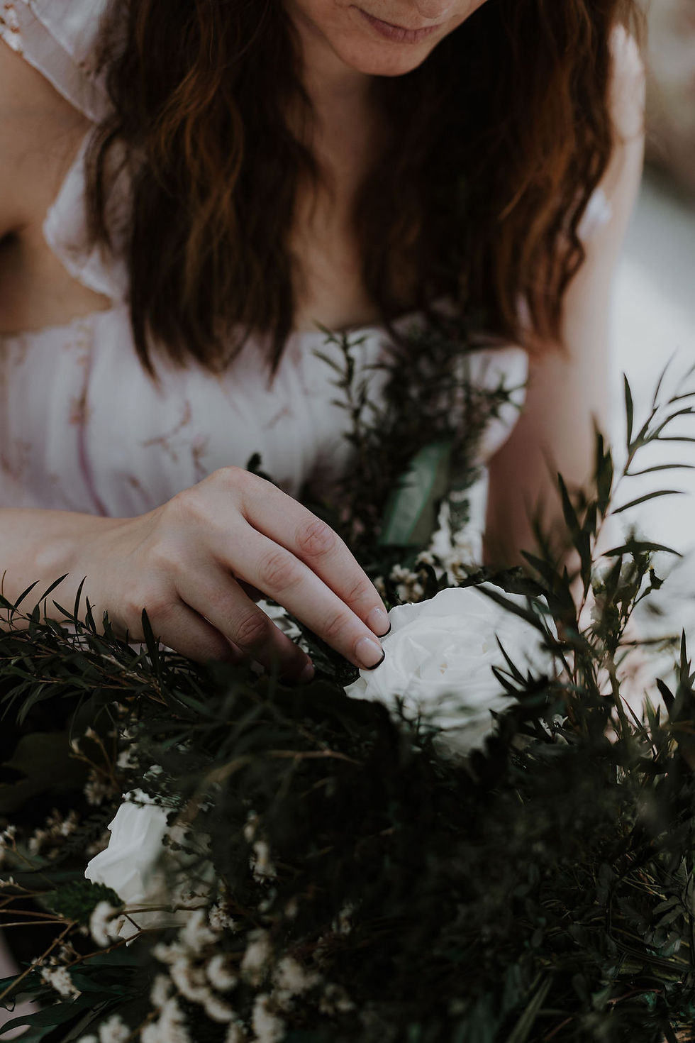 wedding business owner arranging a preserved flower bouquet