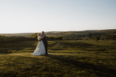bride and groom posing at Danby Castle