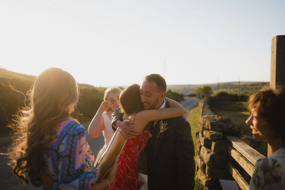 groom hugging guests at Danby Castle