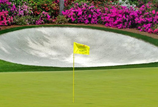 Presence in leadership concept showing a golf green at Augusta National with a flagstick and sand bunker, representing focus, patience, and intentional performance in high-pressure moments.