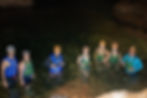 Group photo inside the shallow water of Nohoch Che'en Caves during a Jaguar Paw cave exploration