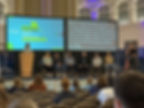 Image with people on stage, showing captioning