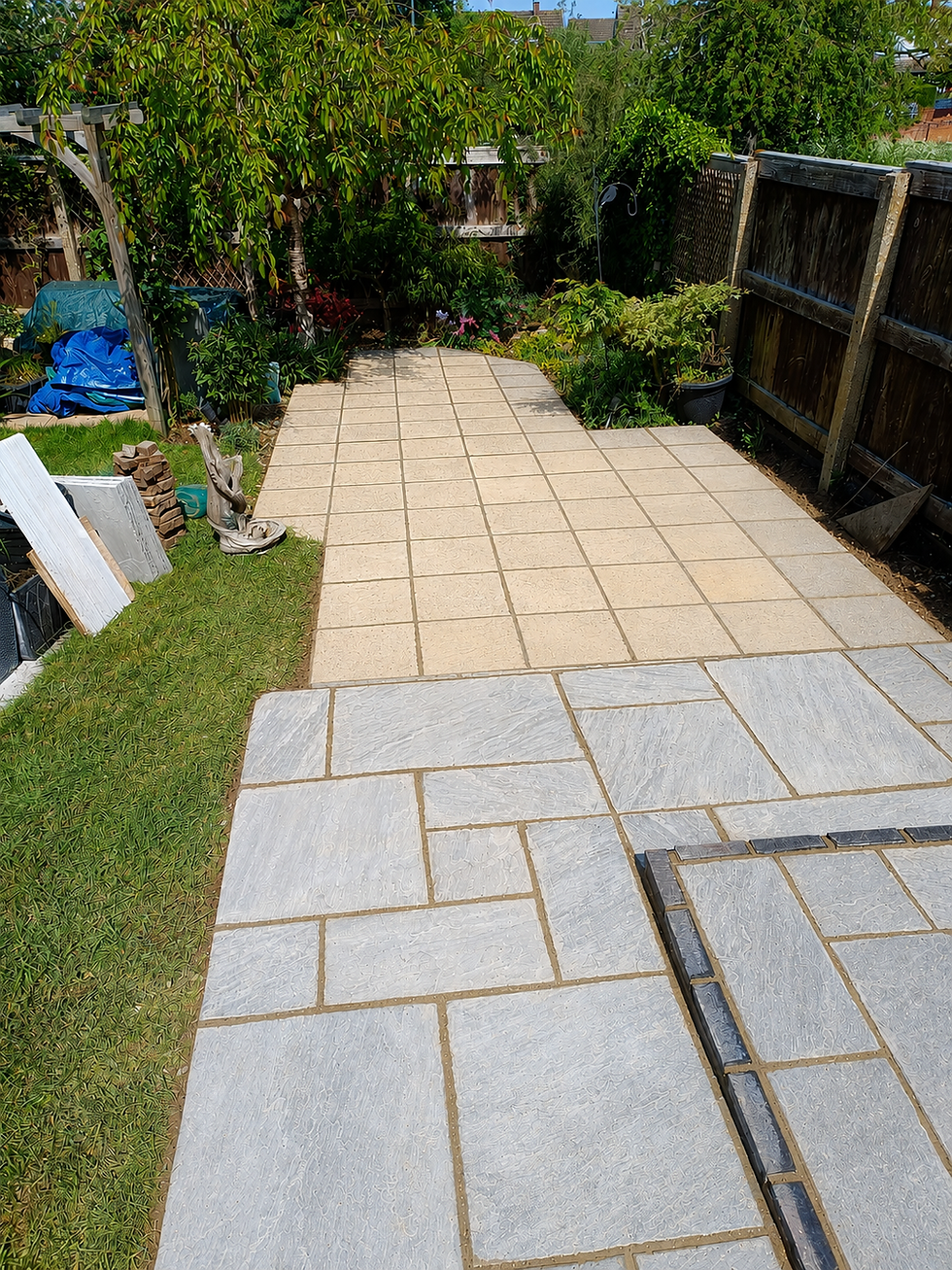 Raised patio with Indian sandstone paving installation in Bedford