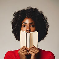black woman with a book held up to her face.jpg