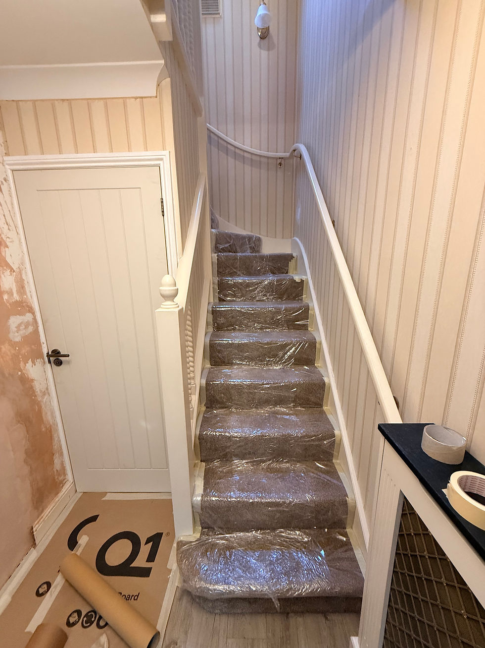 carpet protected with plastic and wood floor protected with card