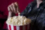 man-eating-popcorn-cinema-2048x1367.webp