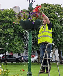 Ger Deere watering flowers on The Mall