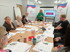 Therapist delivering workplace mental health training to care industry professionals