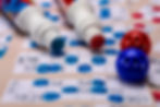 Bingo cards with red and blue markers close up.jpg