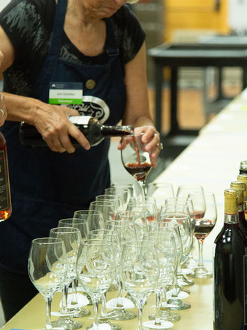 Volunteers filling wines to be judged at the 2024 ICCWC