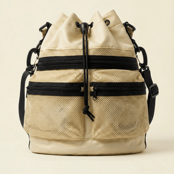 Beige mesh drawstring bag with black zippers and adjustable webbing strap.