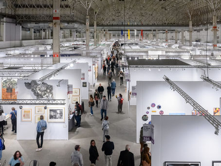 Overhead view of a large conference hall holding many art gallery booths