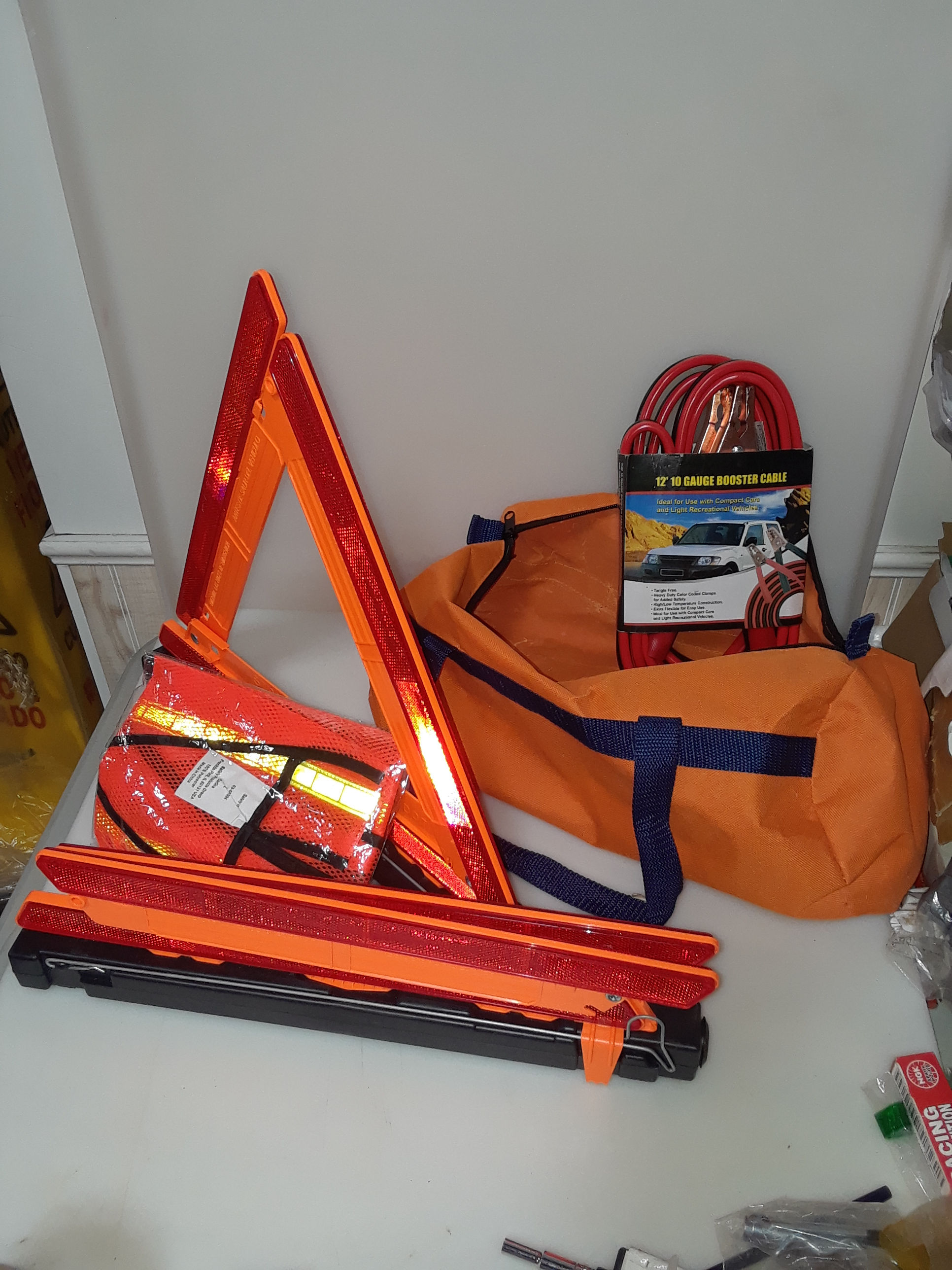 safety triangles booster cables and vest with bag