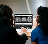 Two women looking at a computer screen w