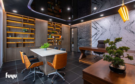 Private meeting space with marble feature wall, warm lighting, and minimalist furniture for a professional tone.