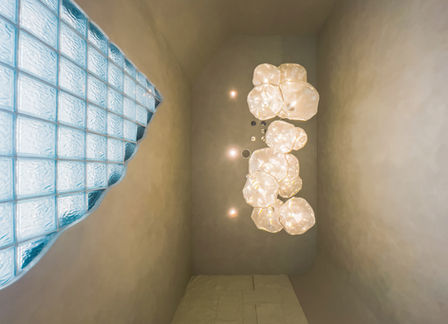 Corridor lit by glass block window and pendant lights creating a soft glow at Bella Clinic Iconic Eco Ardence