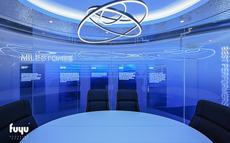 Milestone meeting room featuring circular table, illuminated glass panels, and sculptural ceiling light at Sunstrong Films & Thousands of Years Media Office.