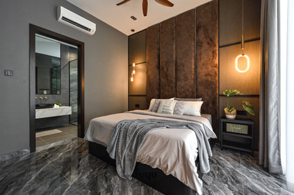 Contemporary bedroom featuring brown suede wall panels and marble flooring leading to ensuite bathroom at Loo’s Residence Sungai Buloh