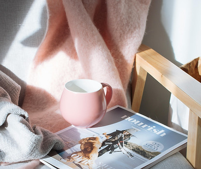magazine on a chair with a coffee mug