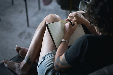 person writing in a journal