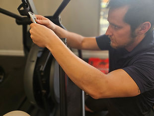 Reimagine Resources certified technician fixing an exercise bike