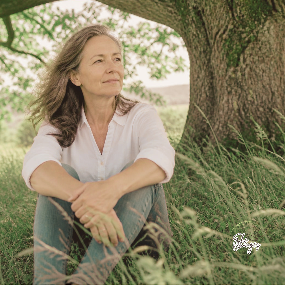 A woman sat by a tree