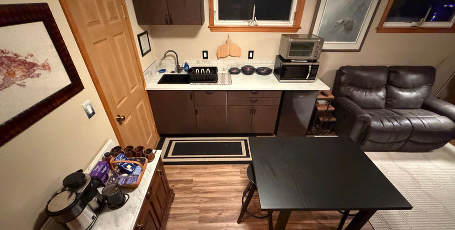 Kitchenette includes microwave, toaster oven, mini-fridge, coffee maker, electric tea kettle, cookware and utensils.